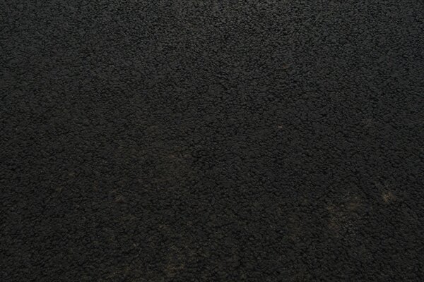 Bild von schwarzem strukturiertem Asphalt