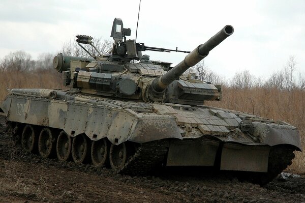 Ein Militärpanzer fährt auf einer schmutzigen Straße